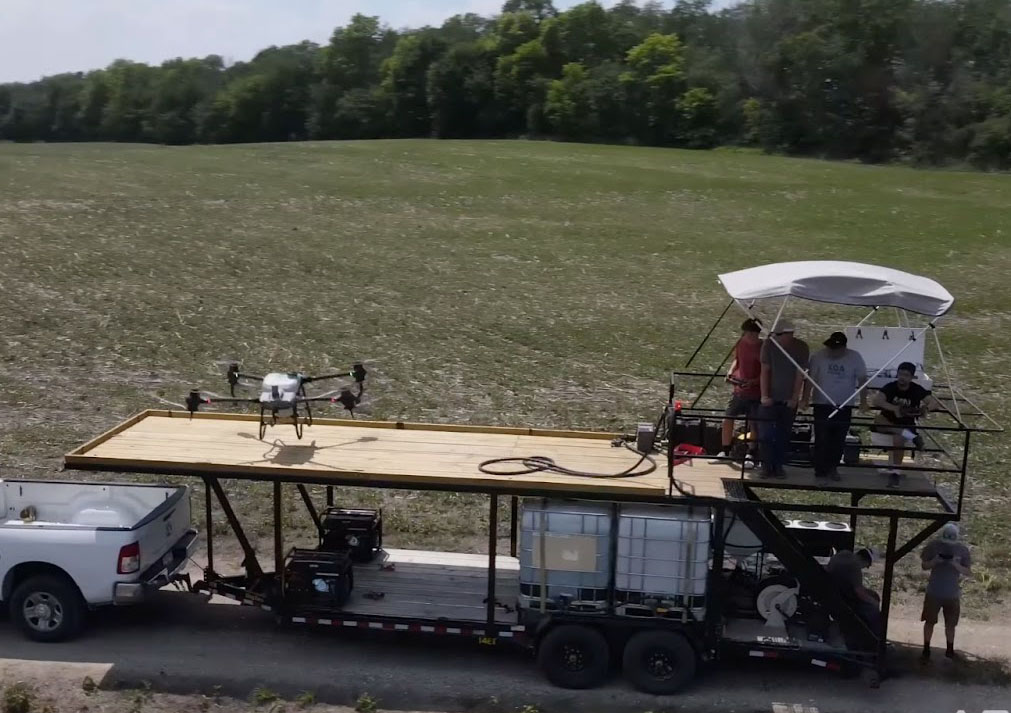 Agricultural drone spraying a crop field