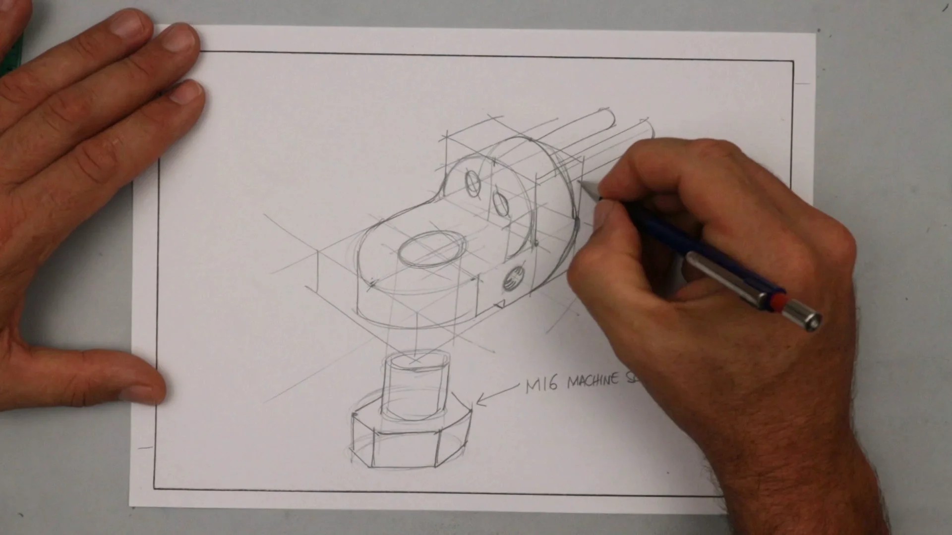 Close-up of hands sketching a simple mechanism