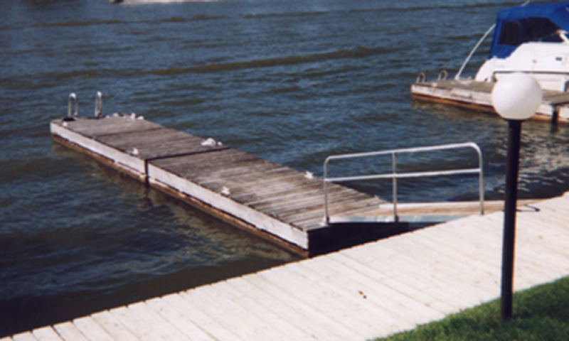 Floating dock with stabilizer hardware on a river